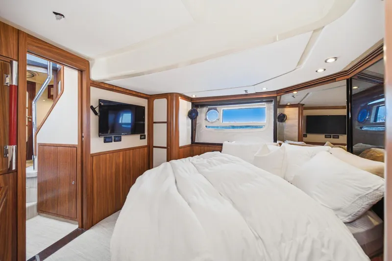 Slide: The Image of Luxurious bedroom interior of 2013 Azimut Magellano 50 yacht with wood paneling and modern amenities. - 44