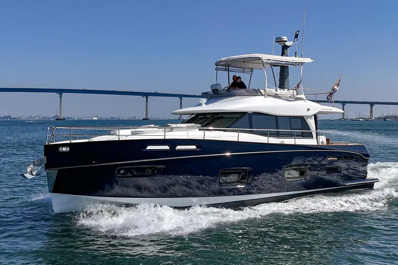 Slide: The Image of 2013 Azimut Magellano 50 yacht cruising on open water with bridge in background. - 45