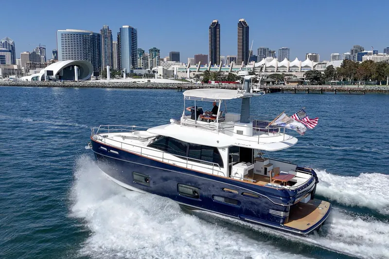 Slide: The Image of 2013 Azimut Magellano 50 yacht cruising near city skyline. - 52