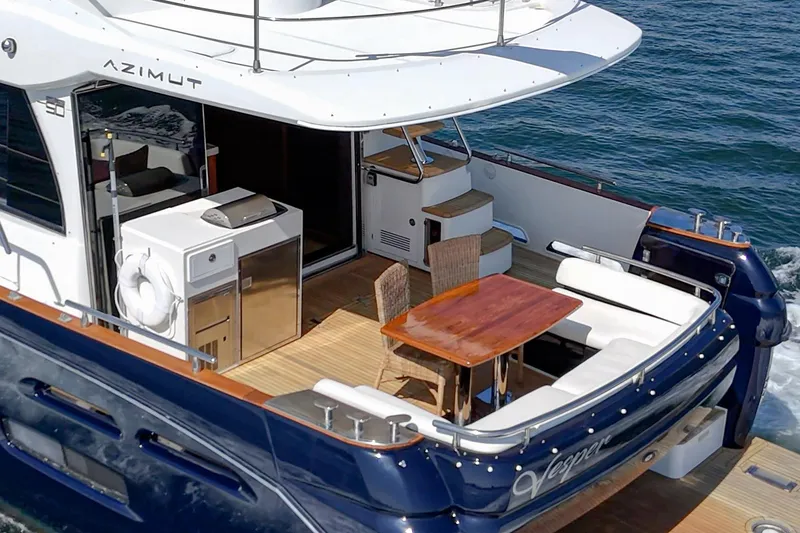 Slide: The Image of Azimut Magellano 50 yacht, 2013 model, featuring elegant outdoor seating and dining area. - 76