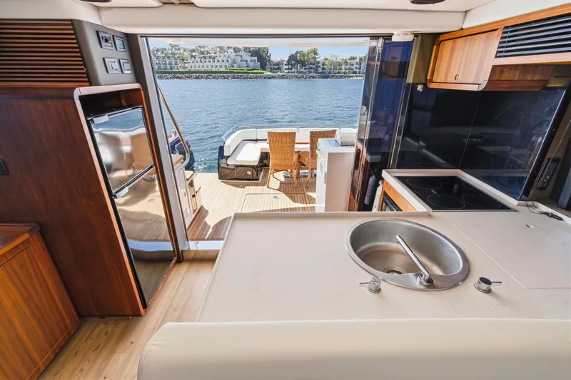 Slide: The Image of Interior view of 2013 Azimut Magellano 50 yacht kitchen and deck area. - 77
