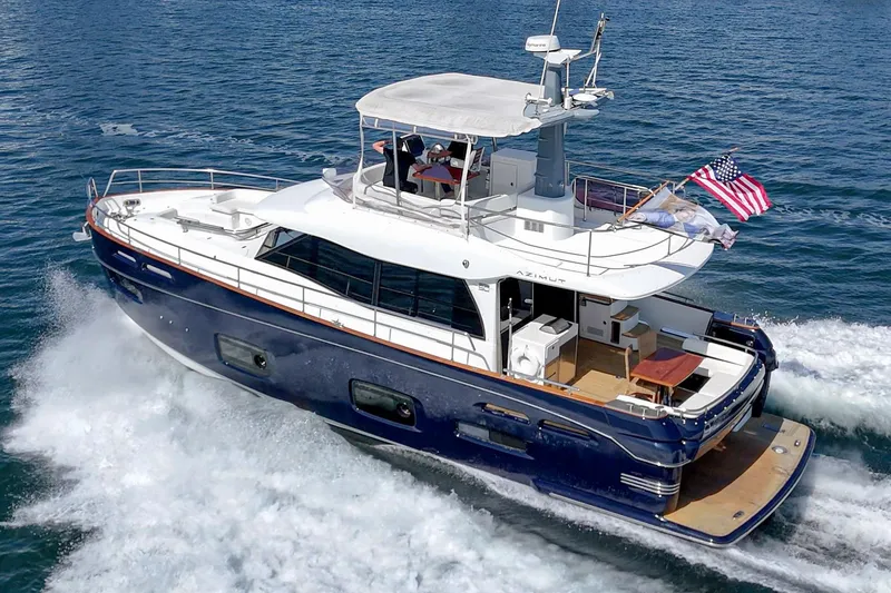Slide: The Image of Azimut Magellano 50 yacht cruising on the ocean, 2013 model, with American flag. - 79