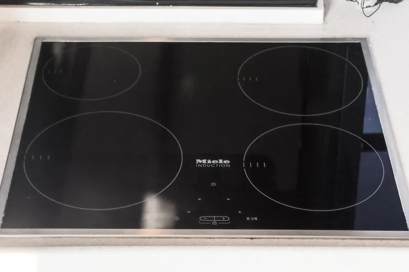 Slide: The Image of Miele induction cooktop on 2013 Azimut Magellano 50 yacht, featuring four cooking zones. - 84