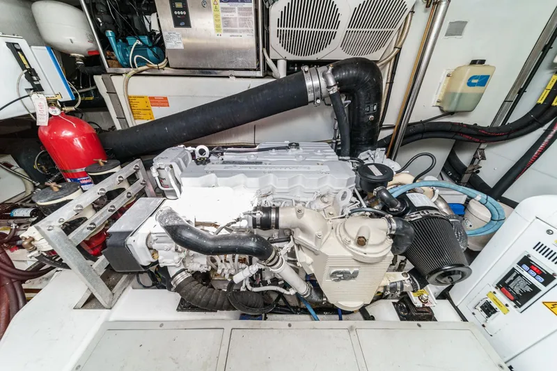 Slide: The Image of Engine room of a 2013 Azimut Magellano 50 yacht, featuring mechanical components and fire extinguisher. - 86