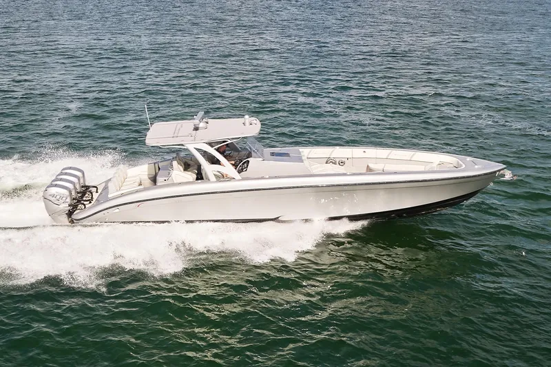 The Image of Midnight Express 43 Open boat cruising on open water, showcasing sleek design and powerful engines. - 0