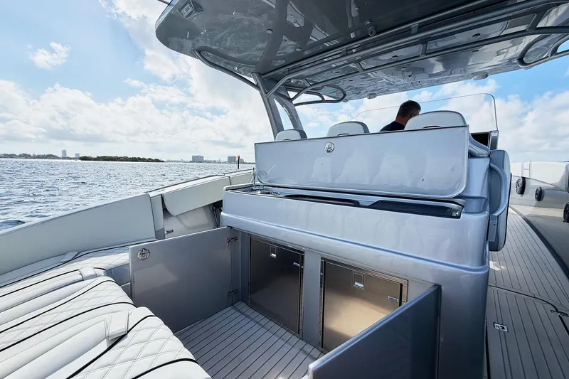 Slide: The Image of Luxury Midnight Express 43 Open boat interior with seating and storage, cruising on a sunny day. - 14