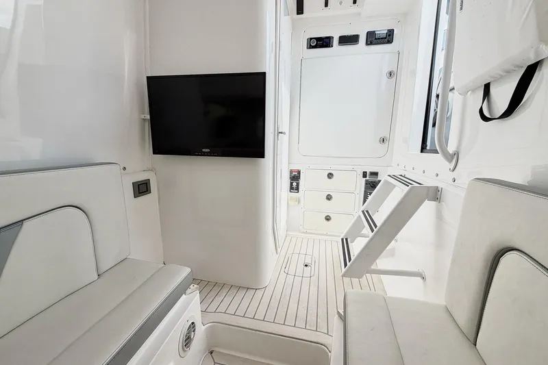 Slide: The Image of Interior of Midnight Express 43 Open boat with seating, TV, and control panel. - 16