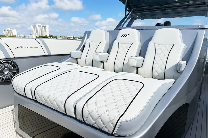 Slide: The Image of Luxurious seating on a Midnight Express 43 Open boat with quilted white upholstery. - 8