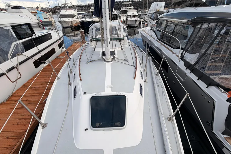 Slide: The Image of 1989 Catalina 34 sailboat docked among other boats at a marina. - 13