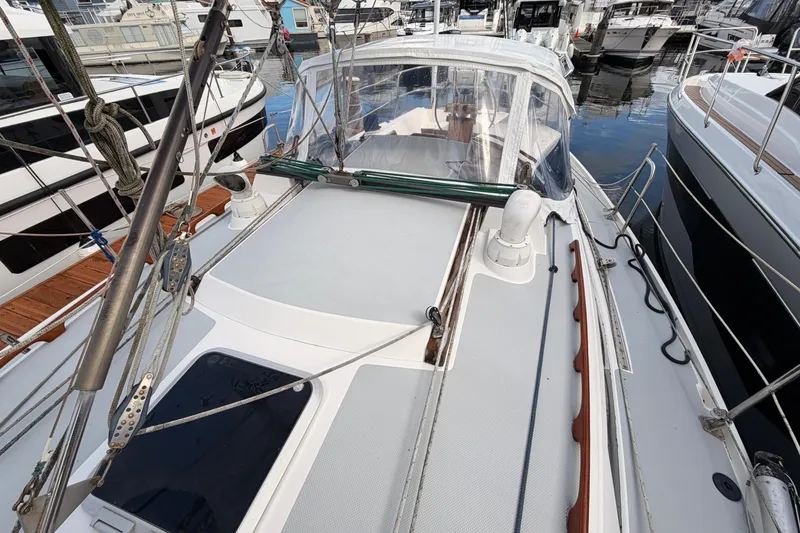 Slide: The Image of 1989 Catalina 34 sailboat docked at marina, showcasing deck and rigging. - 14