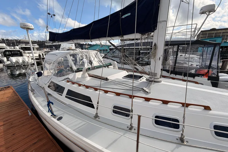 Slide: The Image of 1989 Catalina 34 sailboat docked at marina under blue sky. - 16