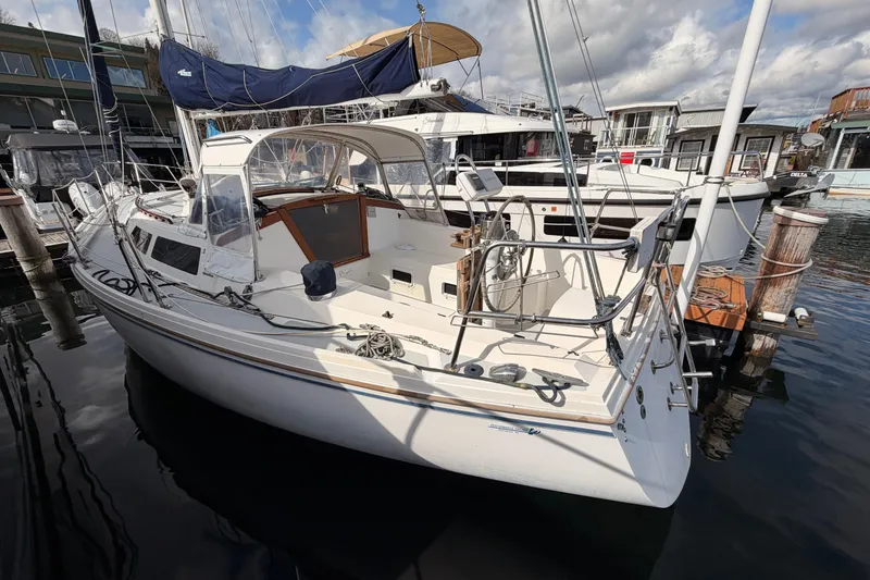 Slide: The Image of 1989 Catalina 34 sailboat docked at marina, featuring spacious cockpit and sleek design. - 17