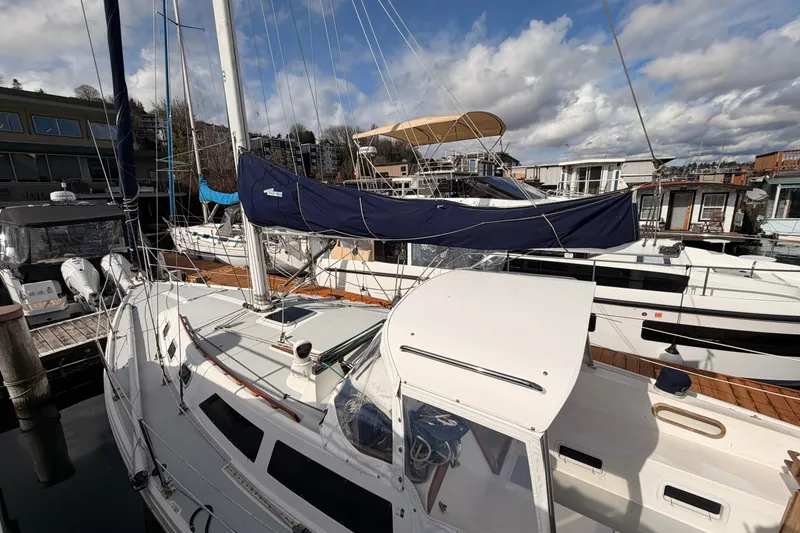 Slide: The Image of 1989 Catalina 34 sailboat docked at a marina under a partly cloudy sky. - 20