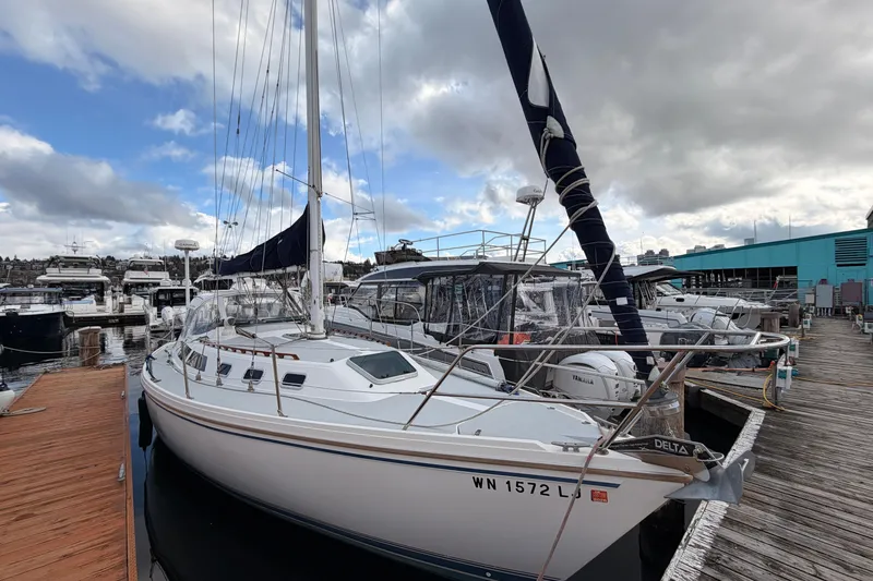 Slide: The Image of 1989 Catalina 34 sailboat docked at marina under cloudy sky. - 3