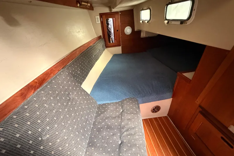 Slide: The Image of Interior cabin of a 1989 Catalina 34 sailboat with cozy seating and bed. - 31