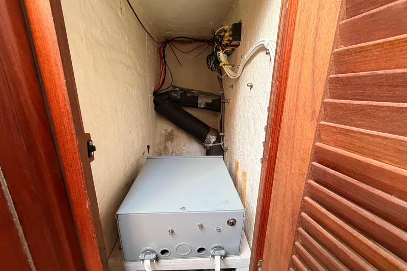 Slide: The Image of Electrical compartment of a 1989 Catalina 34 sailboat with wiring and equipment. - 35