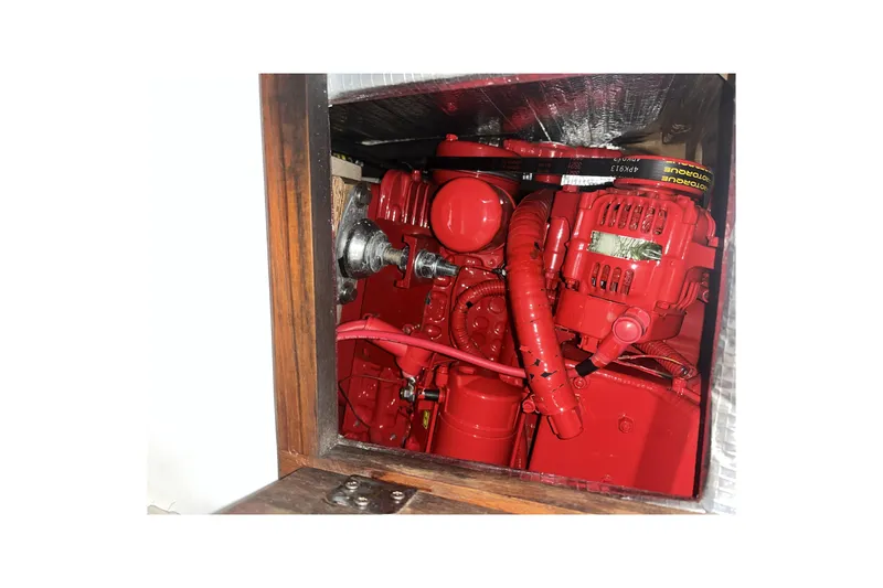 Slide: The Image of Red engine inside a 1989 Catalina 34 sailboat, showcasing detailed components. - 37