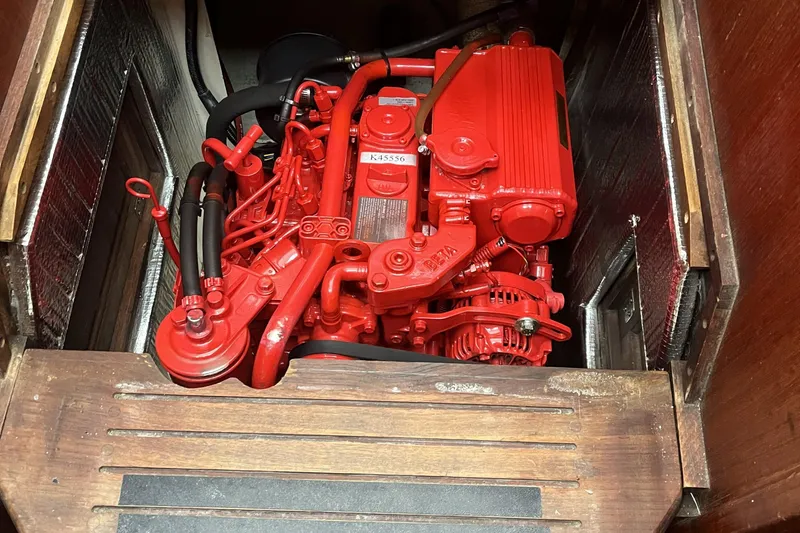 Slide: The Image of Red engine inside a 1989 Catalina 34 sailboat, showcasing detailed mechanical components. - 39