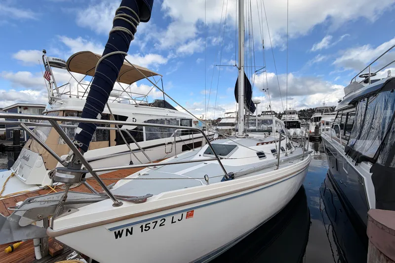 Slide: The Image of 1989 Catalina 34 sailboat docked at marina under blue sky. - 4