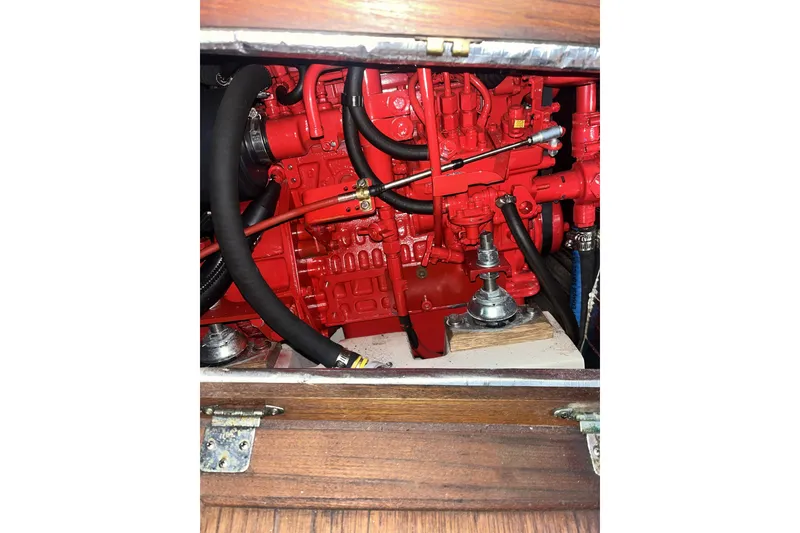 Slide: The Image of Red engine inside a 1989 Catalina 34 sailboat, showcasing detailed mechanical components. - 40