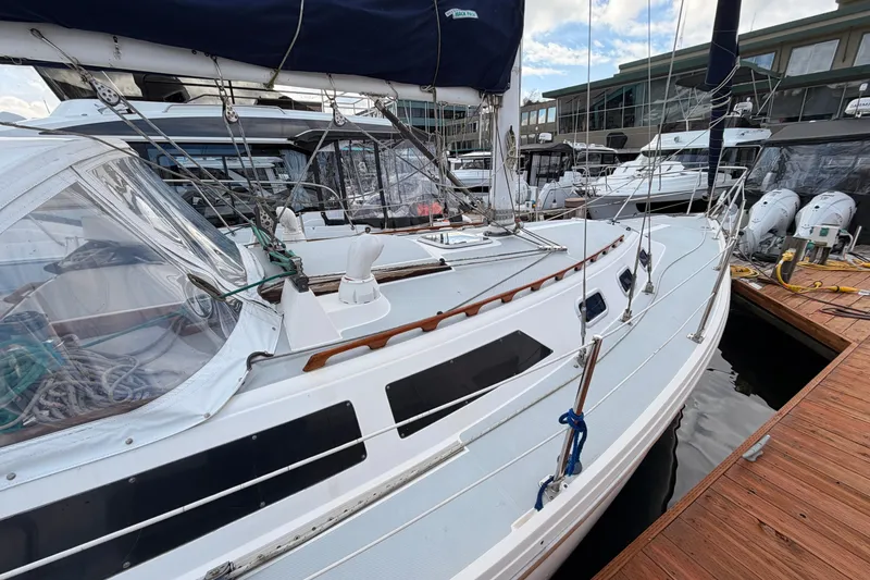 Slide: The Image of 1989 Catalina 34 sailboat docked at marina, featuring sleek design and rigging. - 5