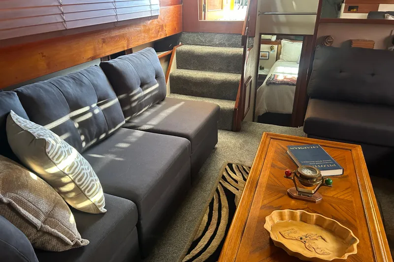 Slide: The Image of Cozy interior of a 1980 Trojan F44 yacht with plush seating and wooden accents. - 10