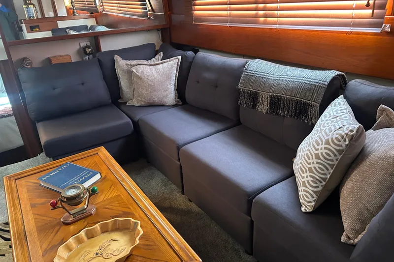 Slide: The Image of Luxurious interior of a 1980 Trojan F44 yacht with plush seating and elegant decor. - 11