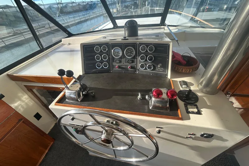 Slide: The Image of Helm of 1980 Trojan F44 boat with steering wheel and control panel. - 13