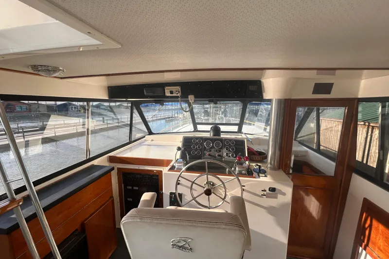 Slide: The Image of Interior view of 1980 Trojan F44 boat cockpit with steering wheel and control panel. - 14