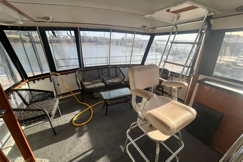 Slide: The Image of Interior of 1980 Trojan F44 boat with seating and river view. - 4