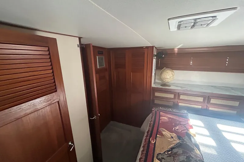 Slide: The Image of 1980 Trojan F44 yacht interior with wooden cabinets and a decorative globe. - 9