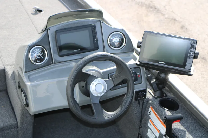 Slide: The Image of 2019 Crestliner VT 18 boat dashboard with steering wheel and Garmin navigation system. - 17