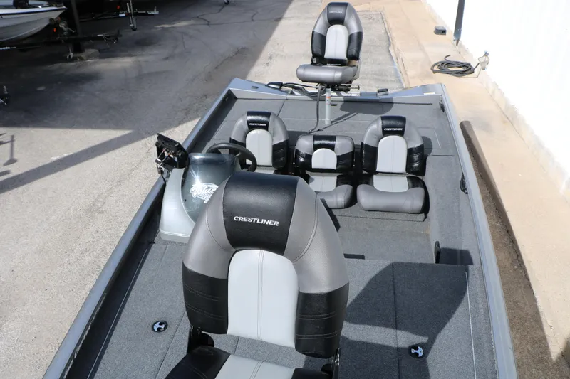 Slide: The Image of 2019 Crestliner VT 18 boat interior with gray and black seating, steering wheel, and console. - 22