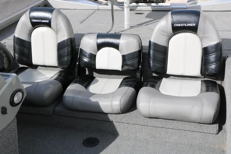 Slide: The Image of 2019 Crestliner VT 18 boat seats, black and gray upholstery, three-seat configuration. - 24