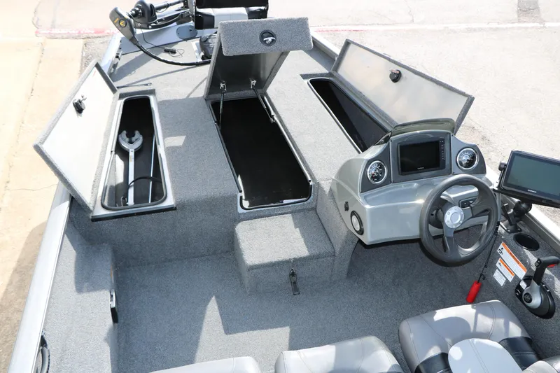 Slide: The Image of 2019 Crestliner VT 18 boat interior with open storage compartments and steering console. - 28