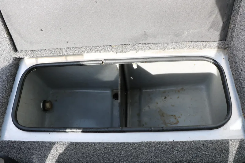 Slide: The Image of Open storage compartment in 2019 Crestliner VT 18 boat, featuring a divided interior. - 29