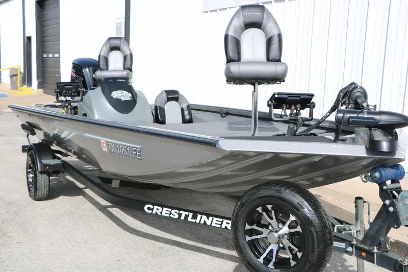Slide: The Image of 2019 Crestliner VT 18 fishing boat on trailer, parked outdoors. - 3