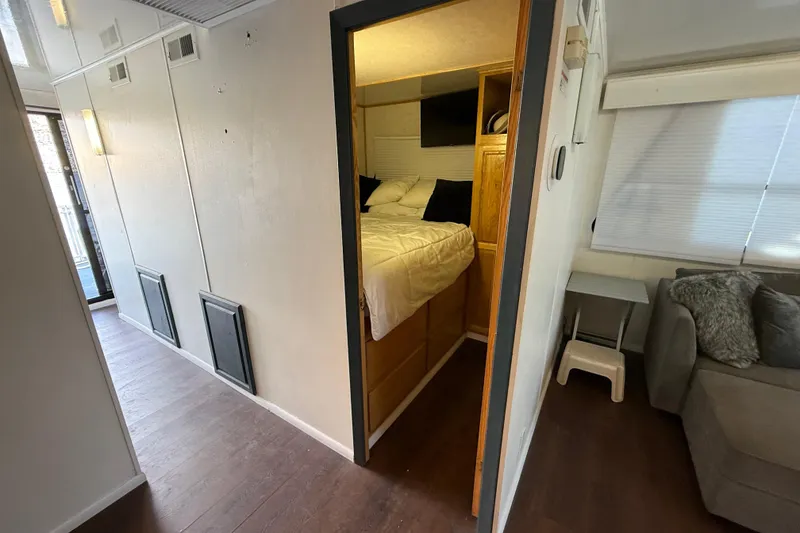 Slide: The Image of Interior of 2006 Fun Country 5014 SunCountry Arizona Edition houseboat, featuring cozy bedroom and living area. - 13