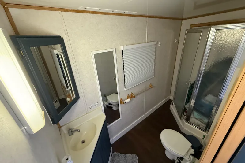 Slide: The Image of Compact bathroom in 2006 Fun Country SunCountry Arizona Edition RV, featuring shower and vanity. - 14