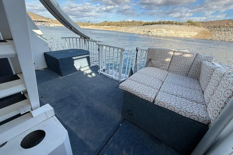 Slide: The Image of Houseboat deck with patterned seating, overlooking serene water and scenic landscape. Fun Country 5014, 2006. - 18