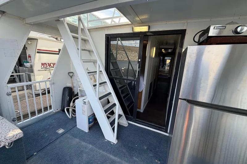 Slide: The Image of Interior view of 2006 Fun Country 5014 SunCountry Arizona Edition houseboat with stairs and appliances. - 21
