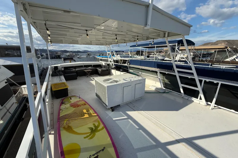 Slide: The Image of Houseboat deck with seating, surfboard, and canopy on a 2006 Fun Country 5014 SunCountry Arizona Edition. - 25