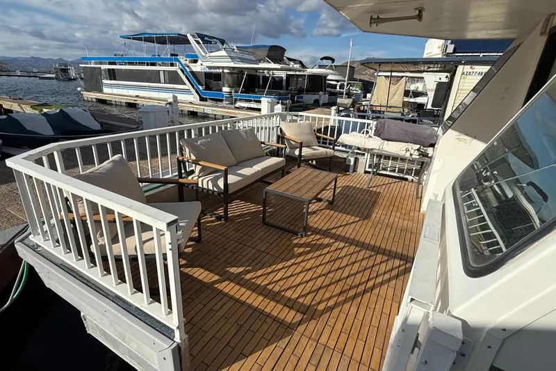 Slide: The Image of Spacious deck of 2006 Fun Country 5014 SunCountry Arizona Edition houseboat at marina. - 3