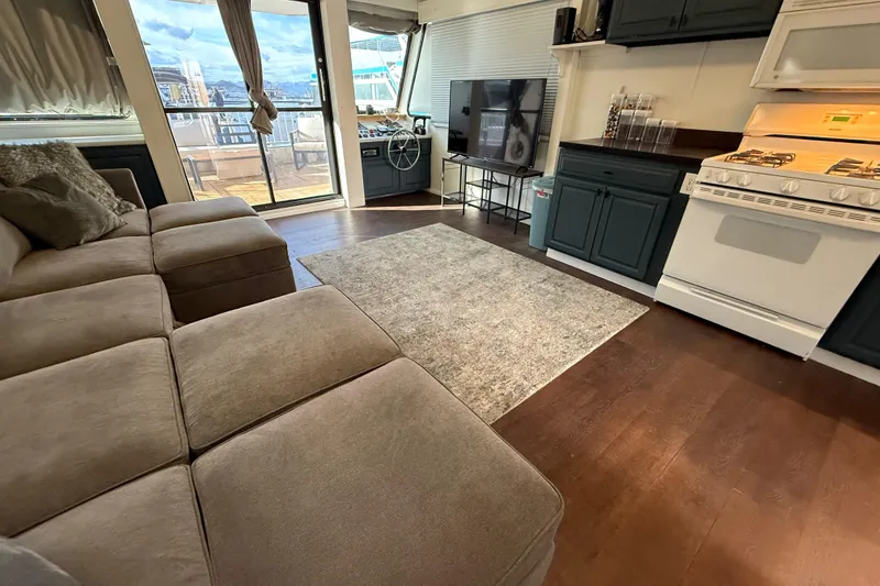 Slide: The Image of Luxurious interior of 2006 Fun Country 5014 SunCountry Arizona Edition houseboat with cozy seating and modern kitchen. - 5