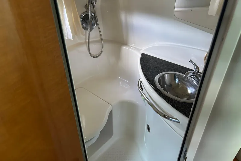 Slide: The Image of Compact bathroom in 2007 Chaparral 330 Signature boat with sink and shower. - 14