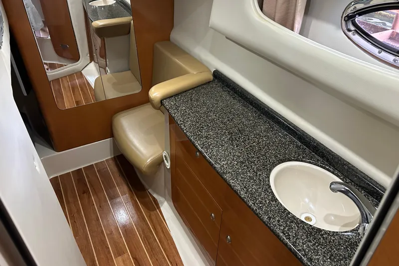Slide: The Image of 2007 Chaparral 330 Signature boat interior with granite countertop and wooden flooring. - 16