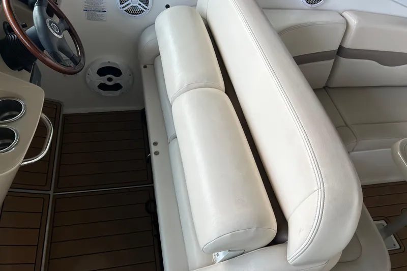 Slide: The Image of 2007 Chaparral 330 Signature boat interior with white seating and wooden flooring. - 18