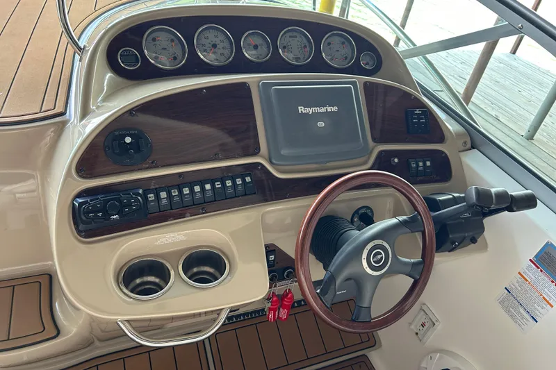 Slide: The Image of 2007 Chaparral 330 Signature boat dashboard with steering wheel and Raymarine display. - 19