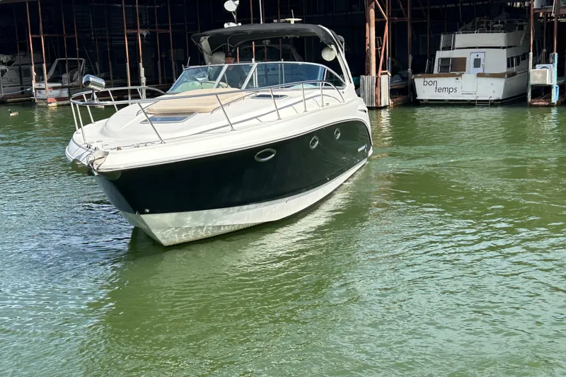 Slide: The Image of 2007 Chaparral 330 Signature boat docked on calm green water. - 2