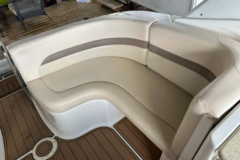 Slide: The Image of 2007 Chaparral 330 Signature boat interior with beige seating and wooden deck. - 21